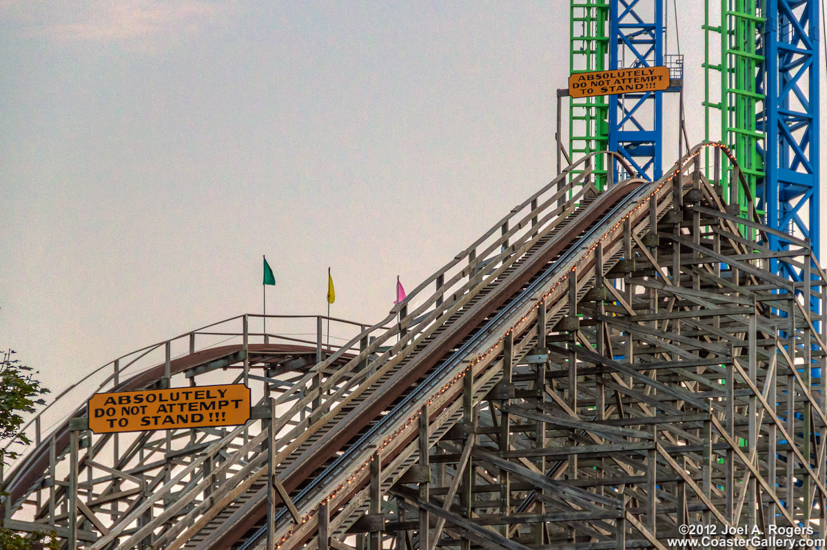 Warning signs on a roller coaster lift hill