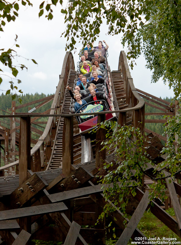 Smiling people riding a roller coaster