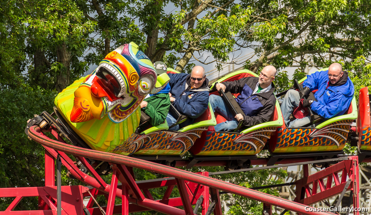 Roller coaster enthusiasts riding a kiddie coaster