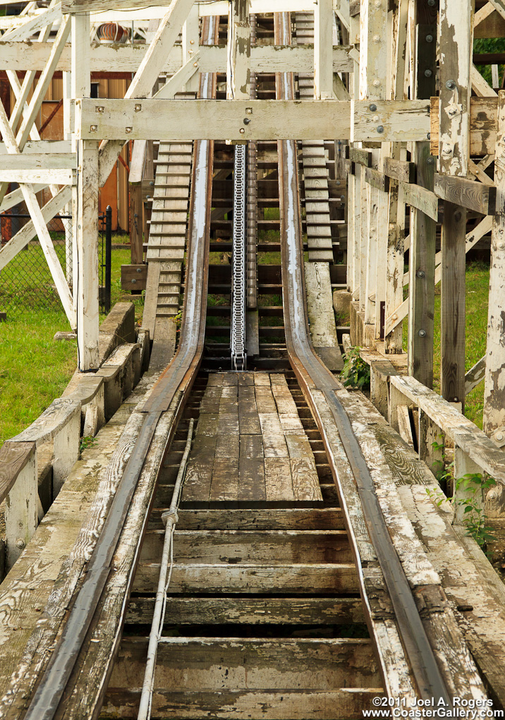 Point of view stock shot of the chain lift on a very old wooden roller coaster