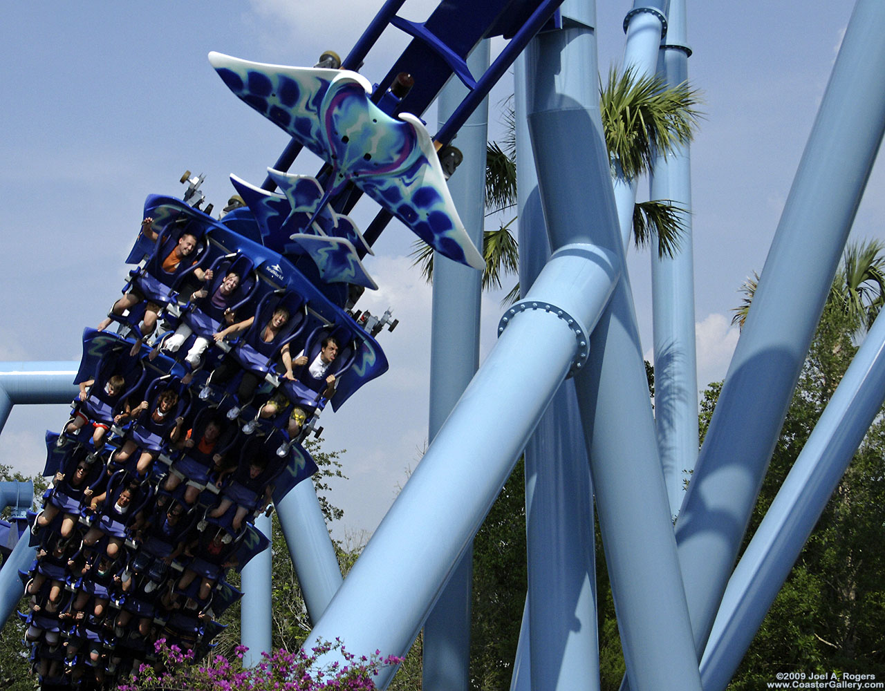 Close-up of a flying roller coaster train and riders