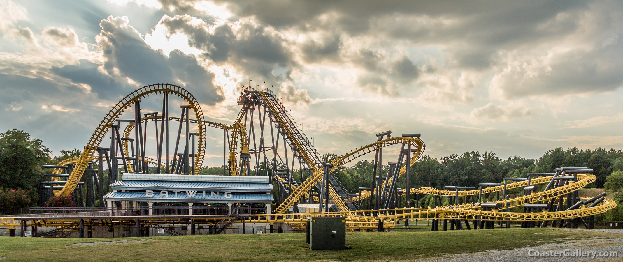 Panorama of a flying roller coaster at sunset